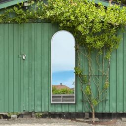 "MirrorOutlet The Arcus - White Metal Framed Modern Arched Garden Wall Leaner Mirror 71"" X 24"" (180CM X 60CM) Silver Mirror Glass with Black All weather Backing."
