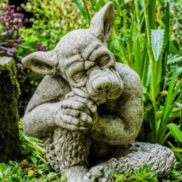 Solid Cast Stone Dog Gargoyle In Sleepy Pose - thumbnail 1