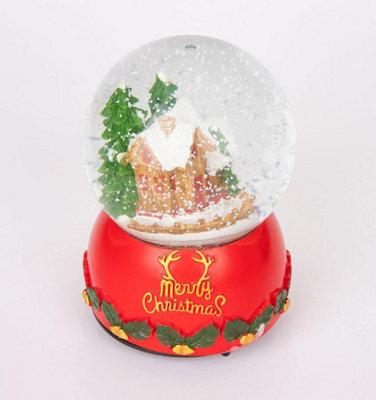 Shatchi Musical Christmas Snowglobe Large Water Ball Features Christmas Village Scene Resin Base Reads Merry Christmas- 10X15Cm - image 1