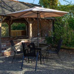 Samuel Alexander Outdoor 4 Person Round Glass Top Garden Dining Table Chairs With Beige Banana Parasol And Base