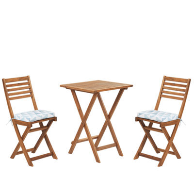 Beliani Bistro Set With Cushions Folding Fiji Acacia Wood Blue - image 1