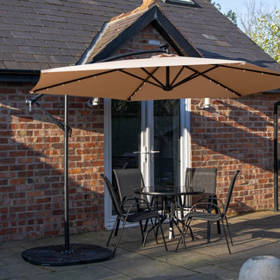 Samuel Alexander Outdoor 4 Person Round Glass Top Garden Dining Table Chairs With Beige Banana Lit Parasol And Base - image 1