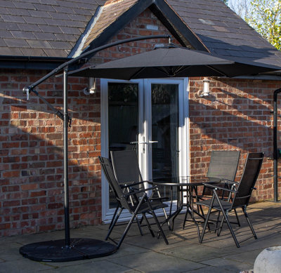 Samuel Alexander Outdoor 4 Person Round Glass Top Garden Dining Table Chairs With Black Banana Parasol And Base - image 1