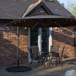 Samuel Alexander Outdoor 4 Person Round Glass Top Garden Dining Table Chairs With Black Banana Lit Parasol And Base
