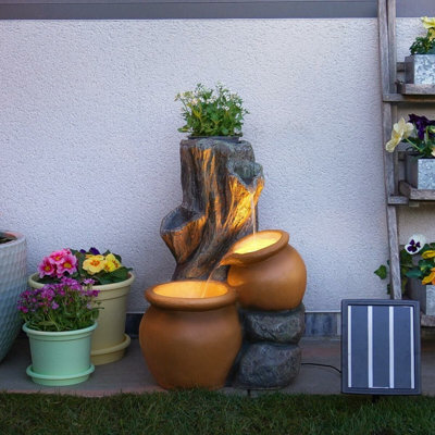Festive Lights Solar & Plug-In Rustic Tree Trunk Terracotta Water Feature With Planter - image 1