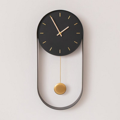 Melody Maison Black & Gold Pendulum Metal Analogue Wall Clock - 20Cm X 55Cm - image 1