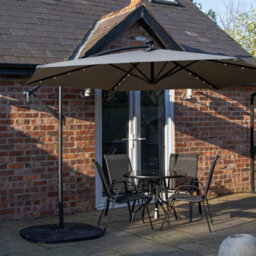Samuel Alexander Outdoor 4 Person Round Glass Top Garden Dining Table Chairs With Grey Banana Lit Parasol And Base