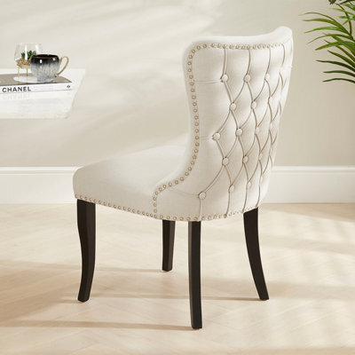 The Furniture Market Boudoir Natural Oatmeal Fabric Wing Back Dining Chair Deep Button Back Chrome Stud Detailing Black Satin Legs Sprung Base - image 1