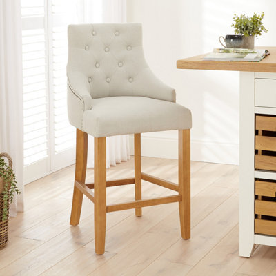 The Furniture Market Luxury Natural Fabric Scoop Back Kitchen Counter Bar Stool Oak Legs Quilted Button Back Stud Detailing Solid Wood Frame - image 1