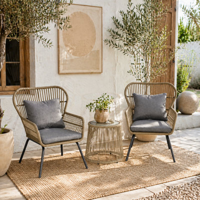 Wyld Haus Luluse 3 Piece Natural Brown Rattan Outdoor Bistro Set With Grey Cushions And Glass Coffee Table - image 1