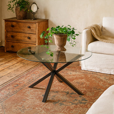 Wyld Haus Saignon 1200mm Round Glass Dining Table With Black Cross-Leg Metal Base - image 1