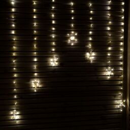 Samuel Alexander 1.2m Battery Operated Snowflake Christmas Curtain Lights with 147 Warm White LEDs in Beige - thumbnail 1