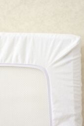 The Tiny Bed Company Waterproof Fitted Mattress Protector for Travel Cot - 95 x 65 cm in White - thumbnail 1