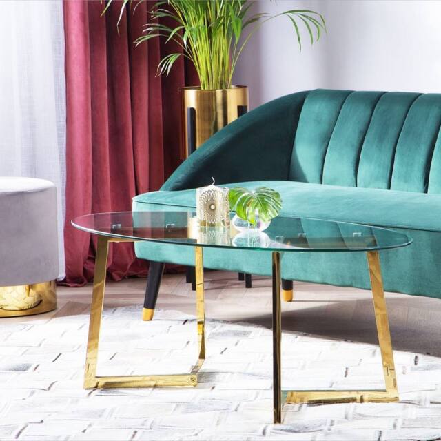 Wyld and Coco Gold-Toned Oval Coffee Table with Tempered Glass Top 120 x 60 cm in Clear - image 1