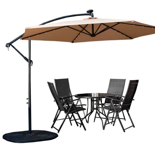Samuel Alexander 4 Person Round Glass Top Table Chairs. Beige Banana Lit Parasol & Base in Black - image 1