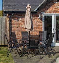 Samuel Alexander Outdoor 6 Person Glass Top Dining Table Chairs. Beige Parasol & Base in Black - thumbnail 3