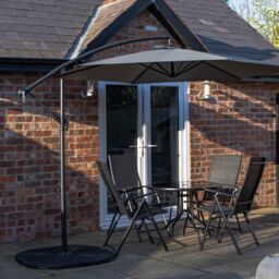 Samuel Alexander Outdoor 4 Person Round Glass Top Garden Dining Table Chairs With Banana Parasol & Base in Grey - thumbnail 2