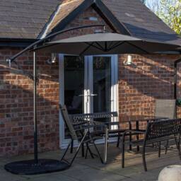 Samuel Alexander Outdoor 6 Person Glass Top Table Benches & Chairs, Banana Parasol & Base in Grey - thumbnail 2