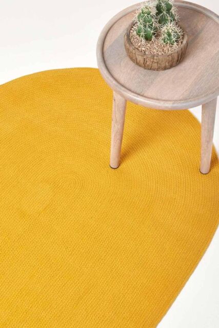 Homescapes Handmade Woven Braided Oval Rug in Mustard - Size: 110 cm x 170 cm - image 1