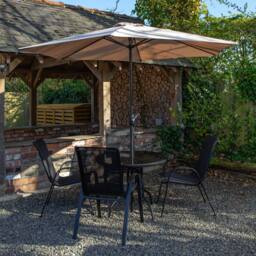 Samuel Alexander Outdoor 4 Person Round Glass Top Garden Dining Table Chairs With Banana Parasol & Base in Beige - thumbnail 2