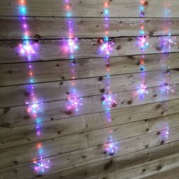 Samuel Alexander 1.3m x 1.2m Light up Snowflake Christmas Curtain Lights with 390 Rainbow & Orange Twinkling LEDs - thumbnail 3