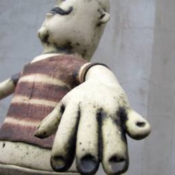 Ceramic Juggler Balancing A Hand Carved Chair - thumbnail 4