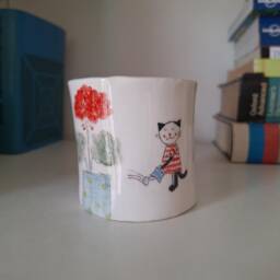 Handmade Ceramic Plant Pot With Cat Watering Flowers - thumbnail 1