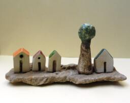 Rustic Ceramic Miniature Houses With Olive Tree On Beach Stone