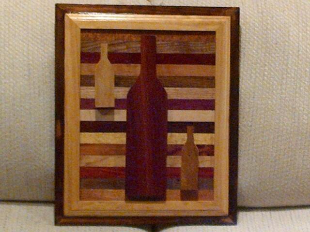 Wood Wall Art Sculpture Featuring 3 Hand Cut Wine Bottle Set in A Variety Of Exotic Hardwood Laminating Strips With Two-Tone Frame - image 1