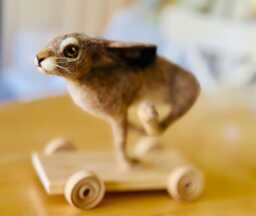 Running Hare On Wheels - Needle Felted Sculpture, Handmade Rabbit Ornament, Woodland Animal Gift, Folk Art Animal - thumbnail 1