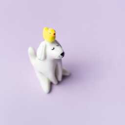 Bantu - Handmade White Porcelain Dog Figurine With Yellow Duck - thumbnail 4