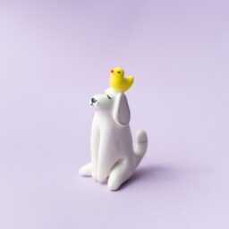 Bantu - Handmade White Porcelain Dog Figurine With Yellow Duck - thumbnail 2