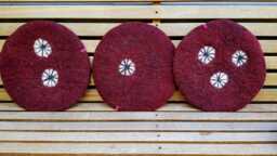Handfelted Seat Cushion With White Wheels, Dark Red