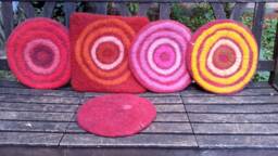 Handfelted Seat Cushion With Coloured Pattern Mix On Red - thumbnail 1