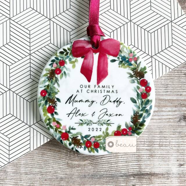 Personalised Christmas Family Names Bow Greenery Wreath Design Ceramic Round Ornament Keepsake