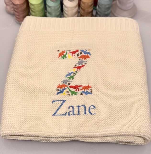 Dino Baby Blanket, Embroidered Dinosaur Alphabet, Knit Newborn Gift, Knitted Blanket For Pram, Custom Name - image 1