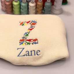 Dino Baby Blanket, Embroidered Dinosaur Alphabet, Knit Newborn Gift, Knitted Blanket For Pram, Custom Name - thumbnail 3