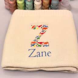 Dino Baby Blanket, Embroidered Dinosaur Alphabet, Knit Newborn Gift, Knitted Blanket For Pram, Custom Name - thumbnail 2