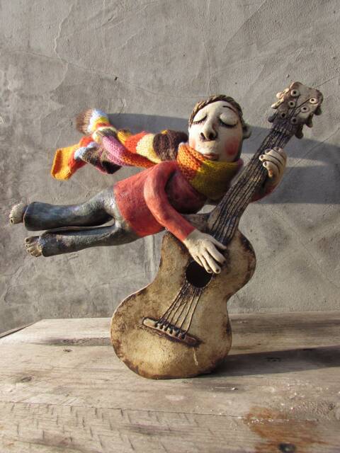 Ceramic Flying Guitarist Wearing A Hand Knitted Striped Scarf - image 1