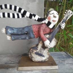 Ceramic Flying Guitarist Wearing A Hand Knitted Striped Scarf - thumbnail 4