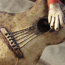 Ceramic Flying Guitarist Wearing A Hand Knitted Striped Scarf - thumbnail 2