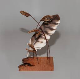 Hand-Carved Barred Owl Feather Suspended By Giant Blue Stem Grass