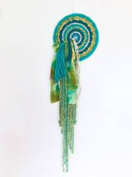 Medusa 8-Inch Round Woven Wall Hanging With Waterfall Fringe - thumbnail 1