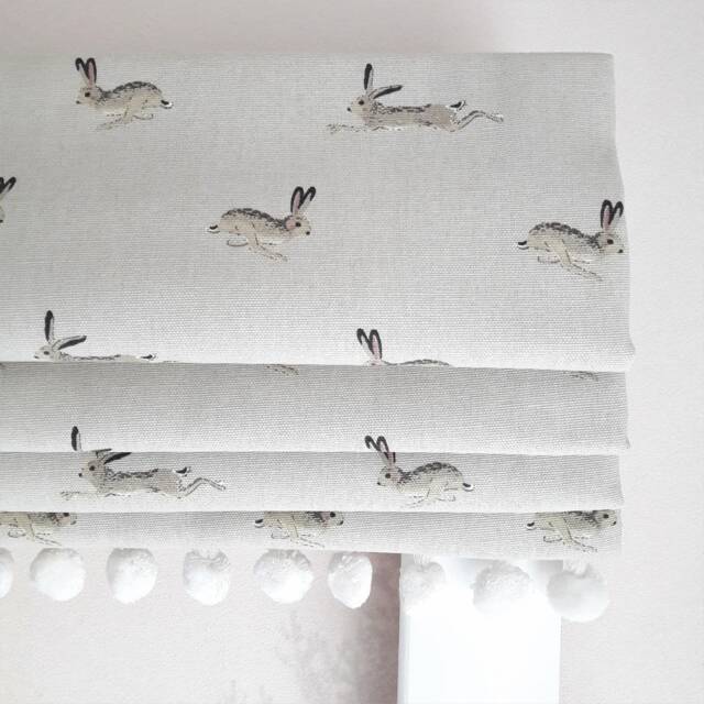 Jumping Hares Blackout Lined Roman Blind With Pom Trim - image 1