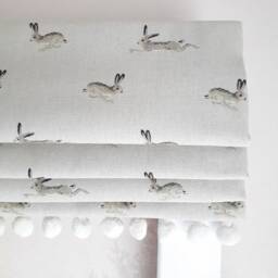 Jumping Hares Blackout Lined Roman Blind With Pom Trim - thumbnail 1