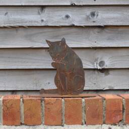 Rusty Metal Cat Licking Paw Statue, Garden Art Decor - thumbnail 1