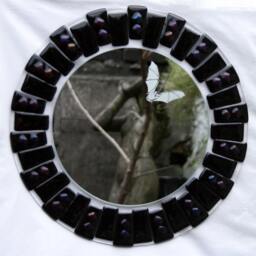 Night Flight ~ A Fused Glass Circular Mirror in Glossy Black With Shimmering Highlights Of Purples & Blue, Etched A Flying Bat