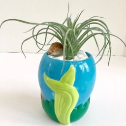 Decorative Planter With Artificial Green Grass Succulent Plant in A Ceramic Seashell - thumbnail 3