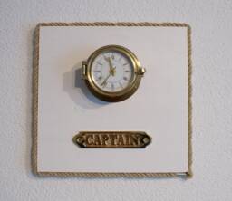 Ship's Clock in The Porthole Of Captain