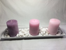 Hand Crafted 5 Piece Scented Pink Candles On White Ceramic Dish With White Pebbles